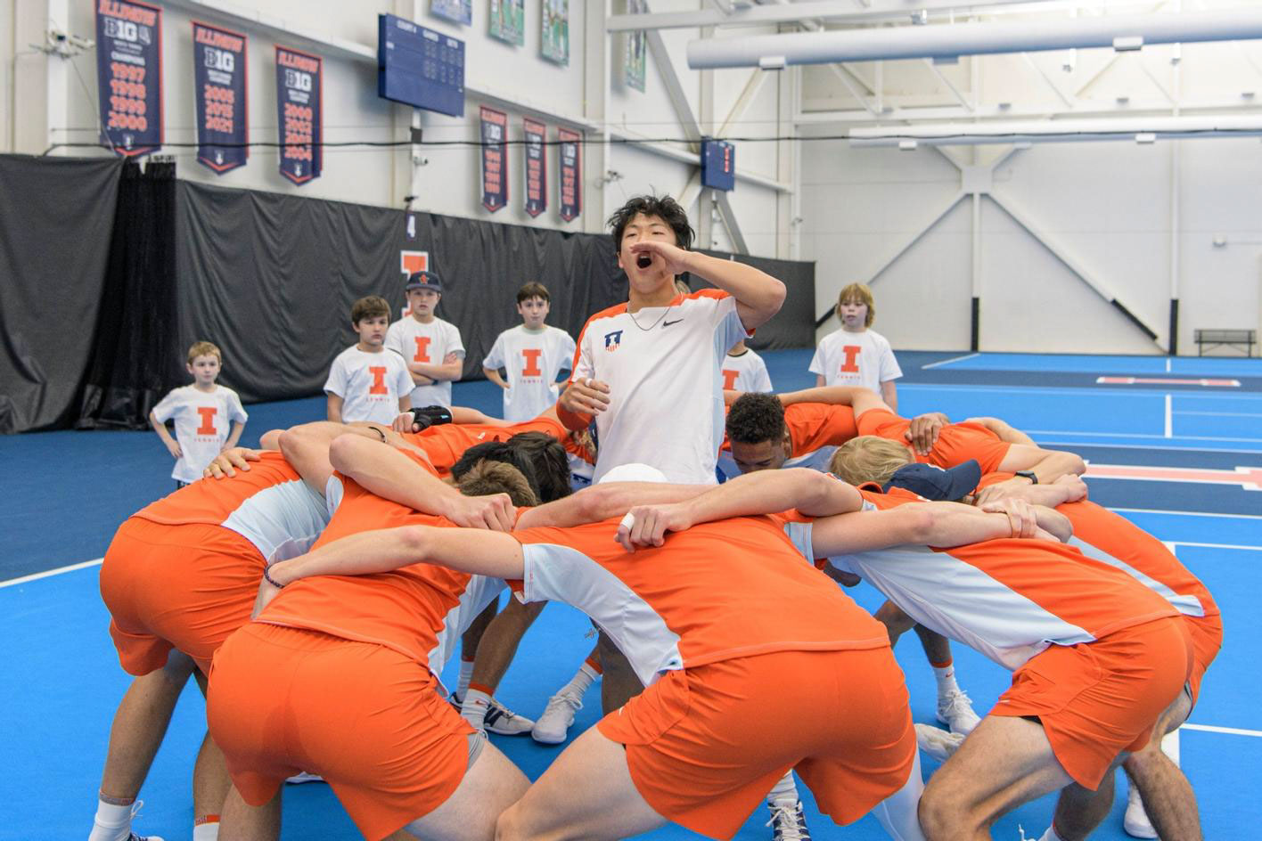 Illinois Men's Tennis players huddle before a match