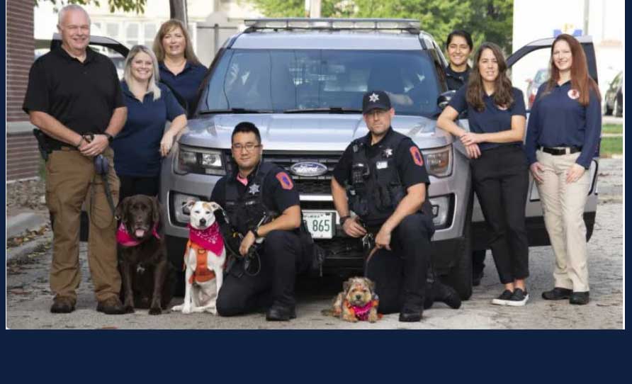 K-9 officers and their sweet dogs pose with the social workers who ride with them as part of the REACH (Response, Evaluation and Crisis Help) program