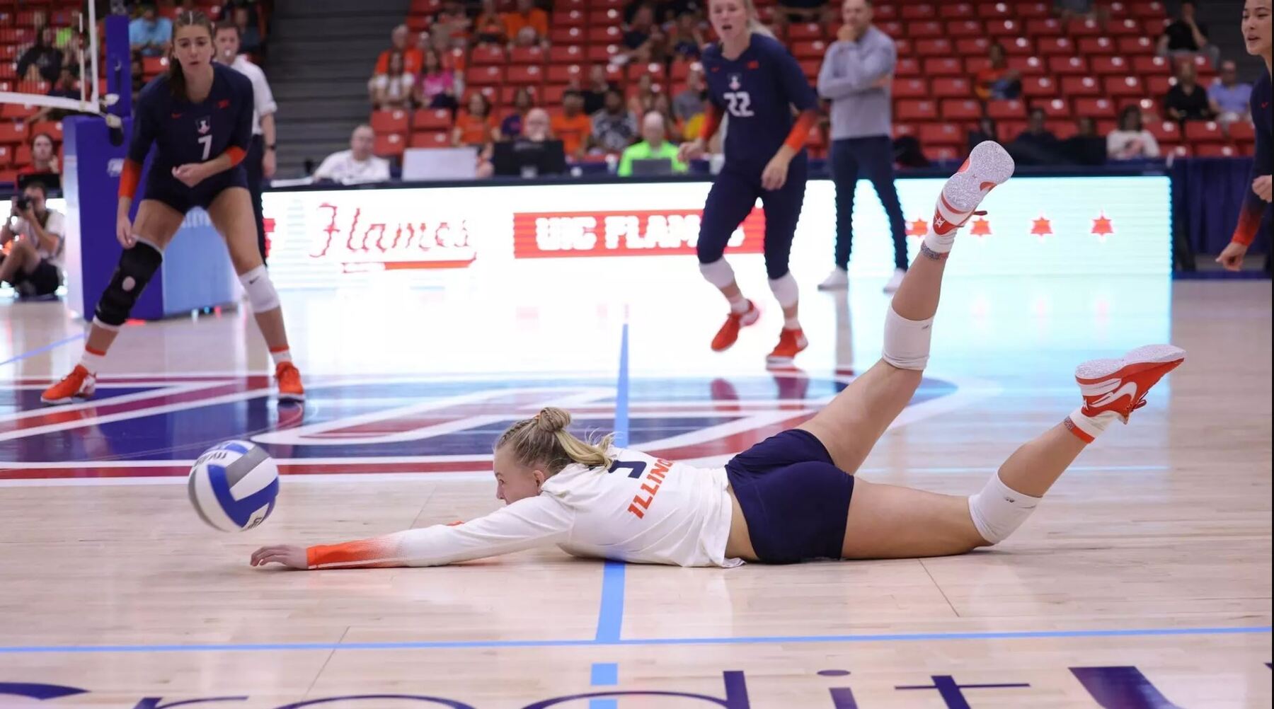 Illini freshman Lily Barry dives for a ball on the court at UIC