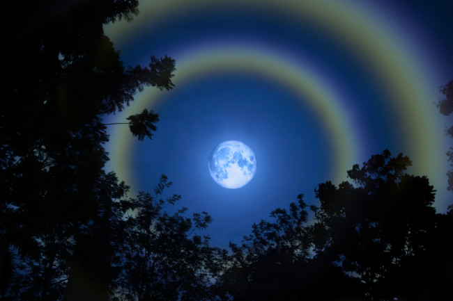 full moon with 'moondoggies' - haloes circling the moon. (Credit: Darkfoxelixir/Shutterstock)
