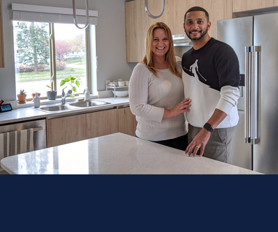 Nancy and Sumanth Viswanathan stand in the kitchen of their new home, ADAPTHAUS, built by U of I students for the D.O.D.'s Solar Decathalon competition