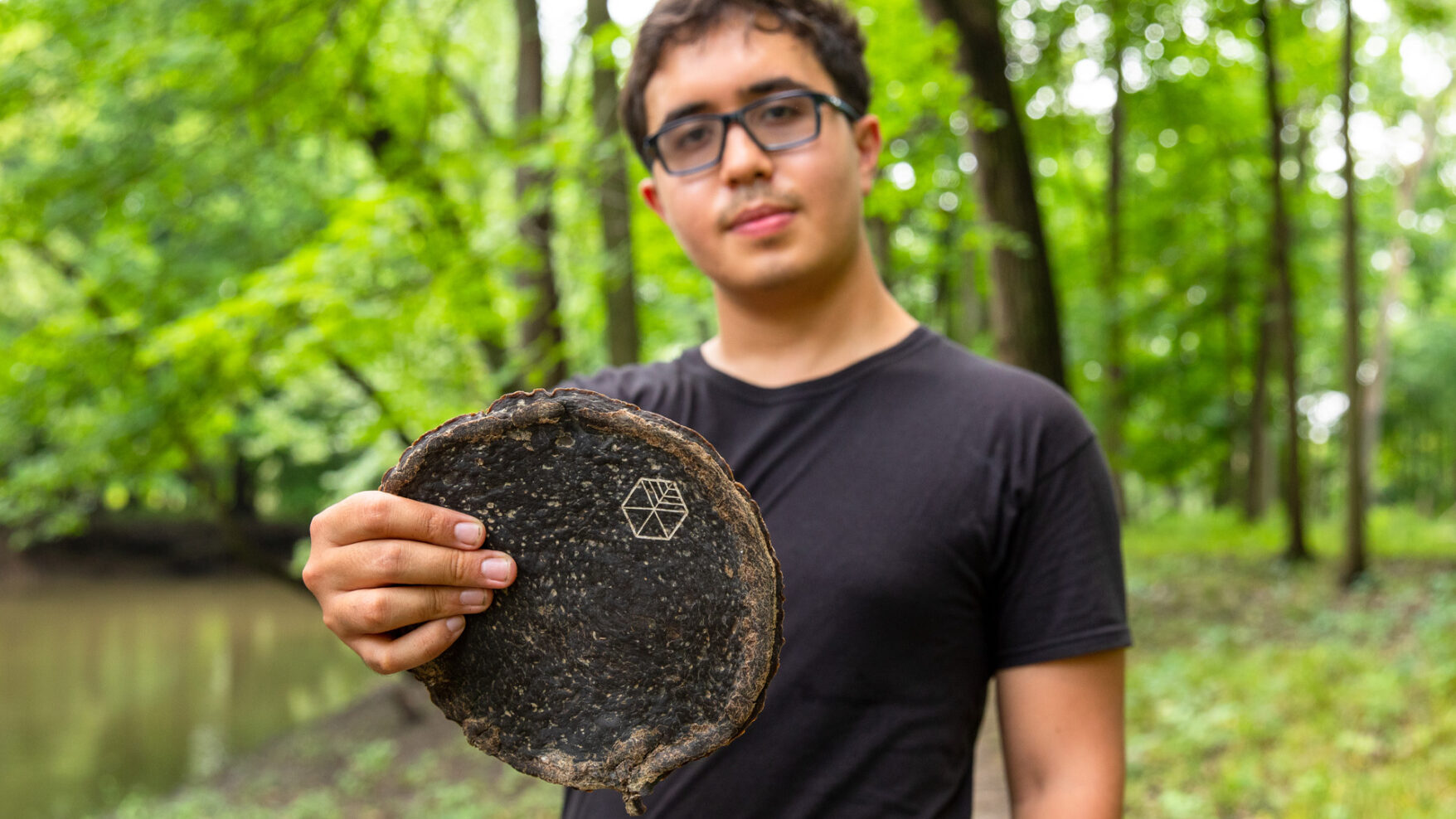 Gabe Tavas holding a piece of Pyrus, the sustainable wood alternative.
