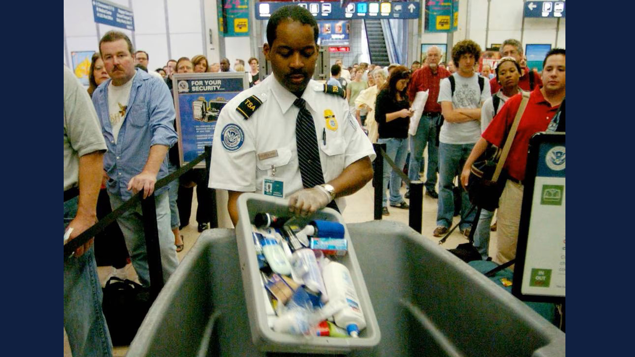 Transportation Security Administration employee Frederick Anderson trashes products collected from passengers at a security checkpoint at Chicago's O'Hare International Airport in 2006. A terrorist plot uncovered in London to destroy planes bound for the United States led to a ban on liquids and gels in carry-on luggage. (David Klobucar/Chicago Tribune)