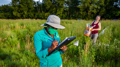 Entomology professor Alexandra Harmon-Threatt and undergraduate student Sabine Miller prepare for an evening of work in a prairie the professor created to study ground-nesting bees.  Photo by Fred Zwicky