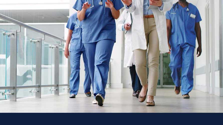 Physicians and nurses walking in the hallway of the hospital. GETTY stock image