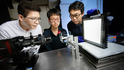 mechanical science and engineering professor Jie Feng, left, graduate student Zhengyu Yang and postdoctoral researcher Bingqiang Ji.  Photo by Fred Zwicky