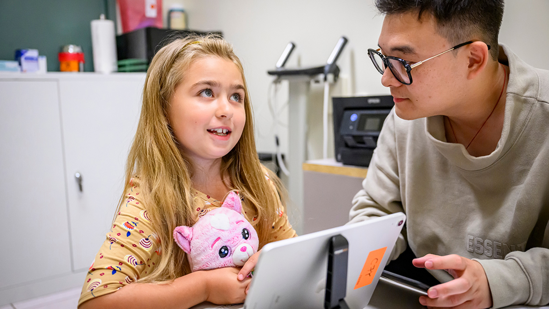 Margo, 7, takes part in a IKIDS screening session with  graduate student researcher Cai Zhang. Photo by Fred Zwicky