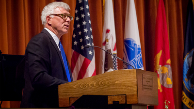 Daniel Sitterly, principal deputy assistant secretary of the Air Force for Manpower and Reserve Affairs, uses the universal design podium while speaking at the May 16 Tri-Service Commissioning Ceremony at Foellinger Auditorium for the U. of I. ROTC program.
