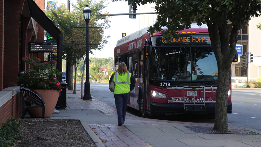 'Orange Hopper' MTD bus at a stop in downtown Urbana