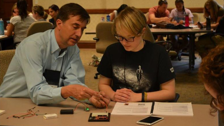 Joe Muskin Muskin works with a camper at this summer's 'Girls Building Awesome Machines' camp.