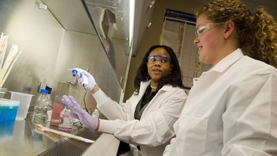 professor Princess Imoukhuede offers a 'hands-on' demonstration to a student in her lab