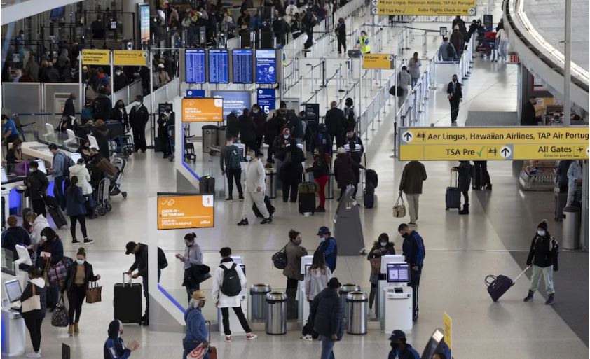 Travelers walk through John F. Kennedy International Airport in New York during the Thanksgiving holiday. (Angus Mordant/Bloomberg)