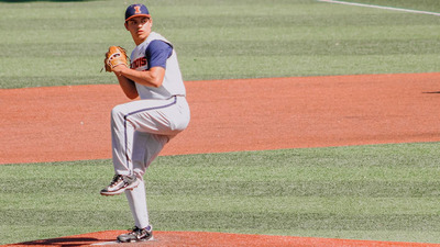an Illini pitcher winds up for his delivery