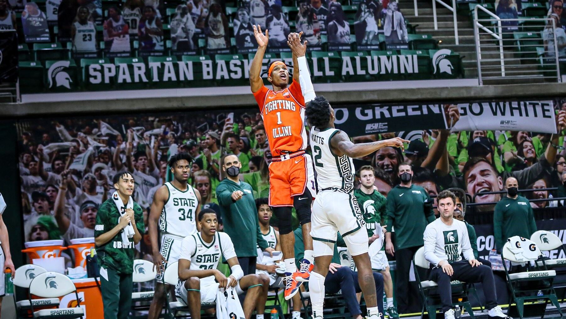Trent Frazier takes a jump shot over Michigan State defenders