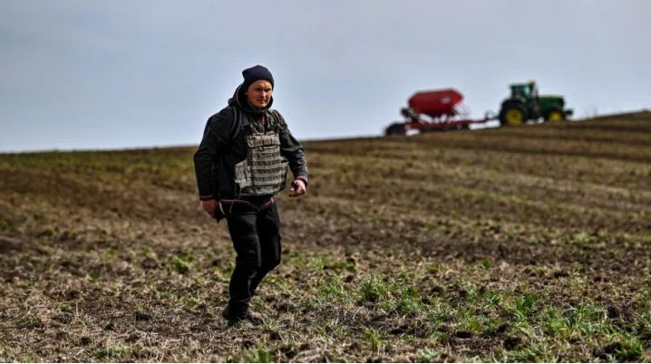 farmer wears a bulletproof vest during crop sowing which takes place 30 km from the front line, Zaporizhzhia Region, southeastern Ukraine. Photo by Dmytro Smoliyenko/ Ukrinform-Future Publishing