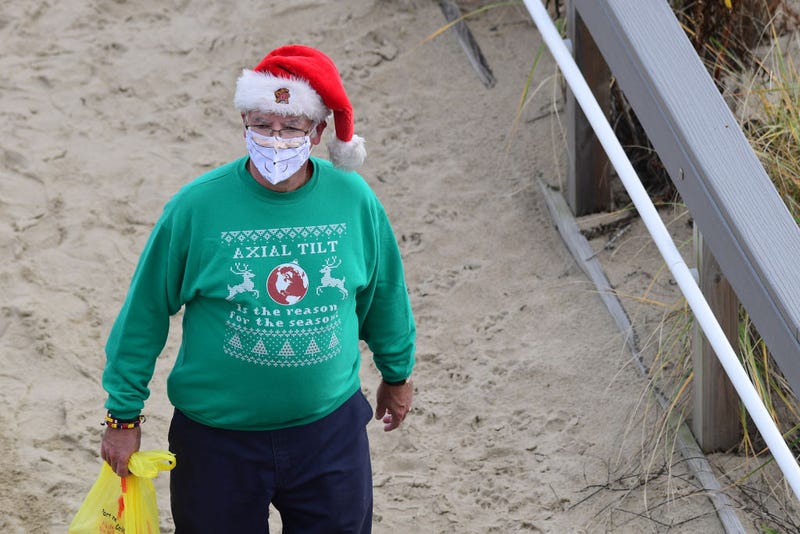 A man with a Santa Claus hat and beard face mask on November 27, 2020 in Rehoboth Beach, Delaware. Photo credit Mark Makela/Getty Images