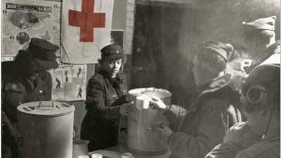 As a Red Cross Clubmobile operator, Knappenberger was initially stationed at Glatton Airfield in England. She's shown distributing coffee