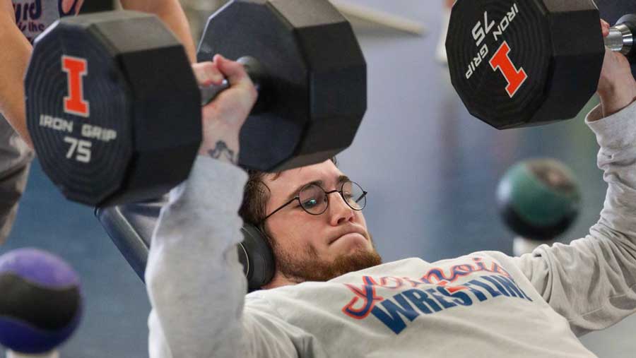 wrestler Lucas Byrd works out with 75 pound dumbbells