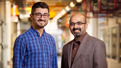 Agricultural and biological engineering professor Girish Chowdhary with postdoctoral researcher Erkan Kayacan. Photo by Brian Stauffer
