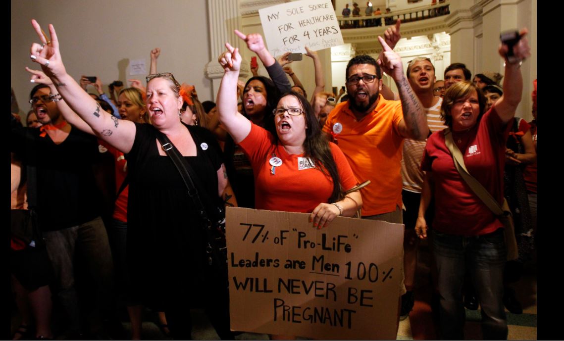 Abortion rights activists demonstrate outside the floor of the House after the HB2 bill restricting abortion rights passed in Austin, Texas July 9, 2013. REUTERS/Mike Stone