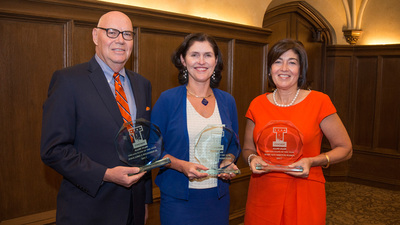 three award recipients post at the awards ceremony
