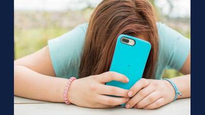 Girl hiding face behind cellphone (Image by Cyn Yoder from Pixabay via Courthouse News)