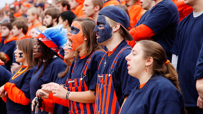students in the 'Block I' cheering section of a Fighting Illini football game. Photo by L. B. Stauffer