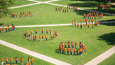 Attendees of the Illinois 4-H Illini Summer Academies form circles on the Quad.