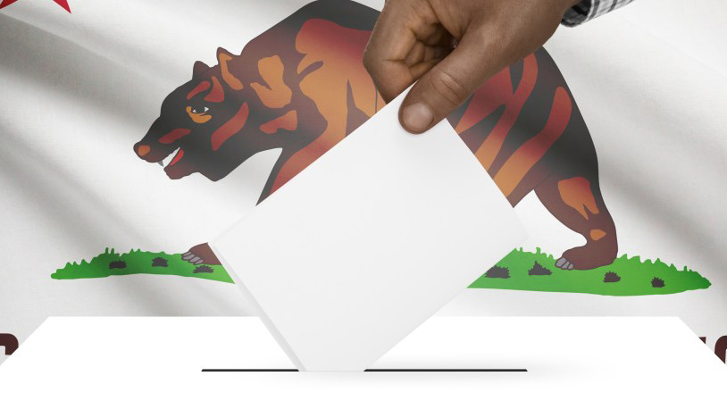 Graphic via Shutterstock. Hand inserts ballot into box in front of California state flag