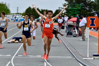Jonathan Davis raises his arms in celebration as he crosses the finish line at the USATF Finals