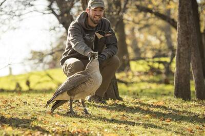 doctoral student Ryan Askren with collared Canada goose