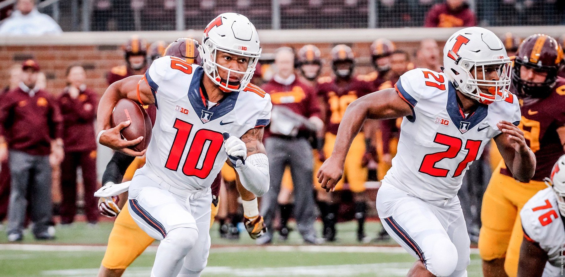 Freshman quarterback Cam Thomas runs the ball during his first appearance with the Illini