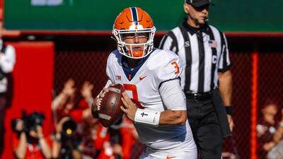 Illinois quarterback Tommy DeVito looks for a receiver as he prepares to pass