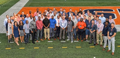 group photo of athletes and coaches who returned to C-U for the reunion