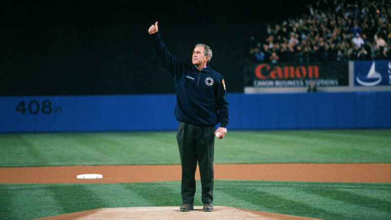 President George W. Bush gives a thumbs up to the Yankee Stadium crowd before throwing the ceremonial first pitch for Game 3 of the 2001 World Series in New York. (Rich Pilling / MLB Photos via Getty Images)