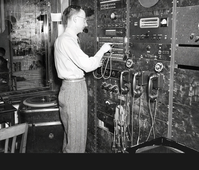 a 1940s-era engineer works at the radio control board at WILL