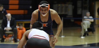 An Illini grappler approaches his opponent