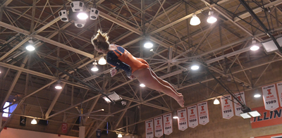 sophomore gymnast Kasey Meeks flies through the air during vault competition