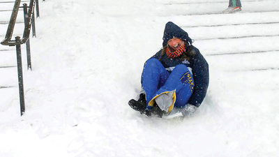 student sleds down the front steps of Foellinger Auditorium in 2007