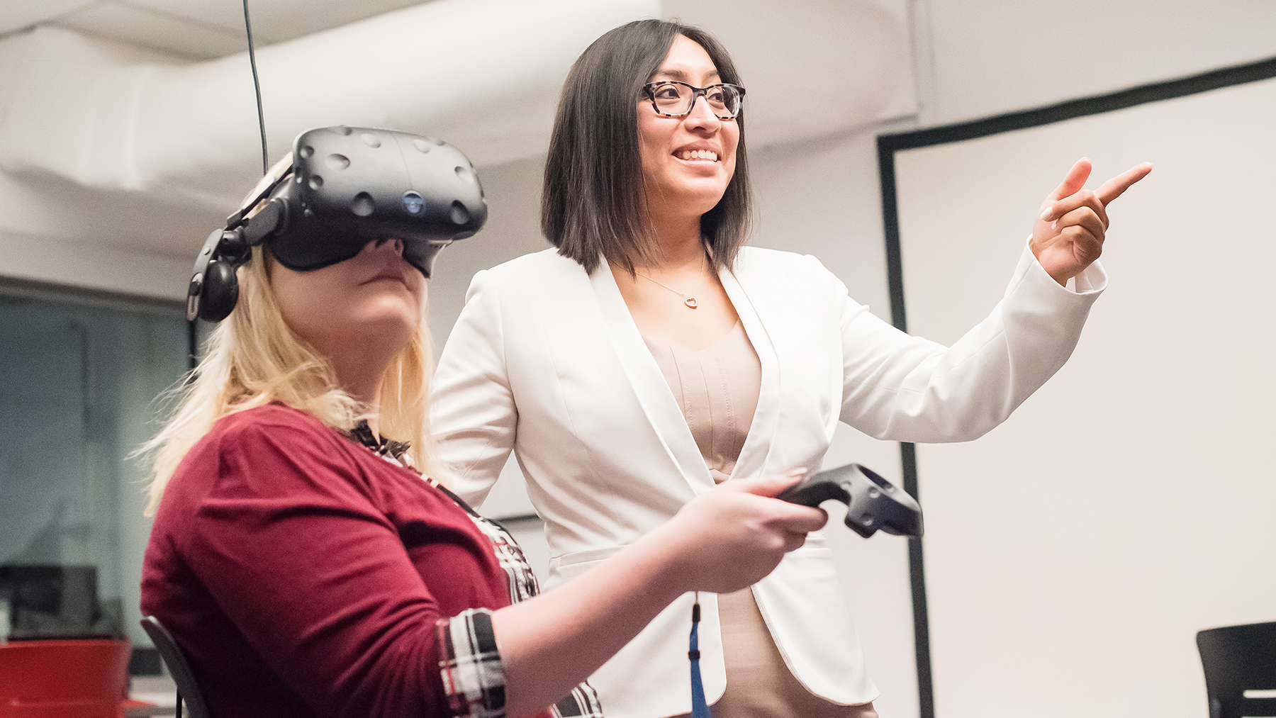 Study authors  Drew Fast and Rosalba Hernandez using VR headset. Photo by Becky Ponder
