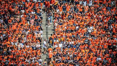 a crowd, nearly all dressed in orange, watch an Illini football game pre-COVID