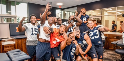 football players goofing for camera in new football facility