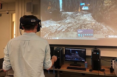 A student at a recent virtual reality open house tests how virtual reality equipment enhances educational experiences in the Department of Anthropology.