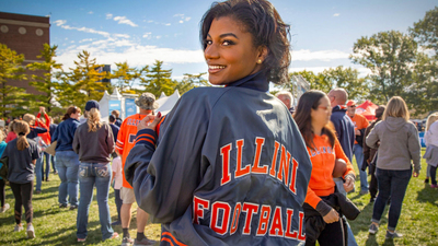 Taylor Rooks, wearing an Illini Football jacket, outside Memorial Stadium