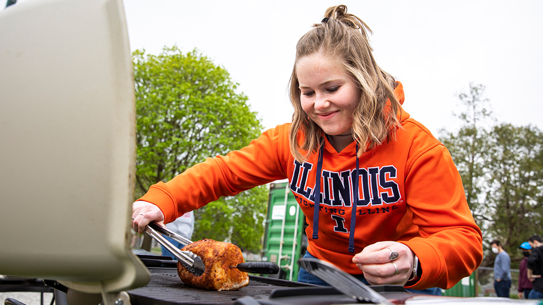 Jenna Spangler prepares a pork roast in this spring’s Grilling and BBQ Science course. Photos by Michelle Hassel