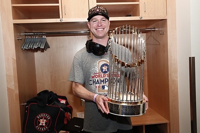 Dan O'Neill ('99, Communications) poses with the World Series trophy in 2017, after the Houston Astros defeated the Los Angeles Dodgers. (Photo courtesy of the Houston Astros.)