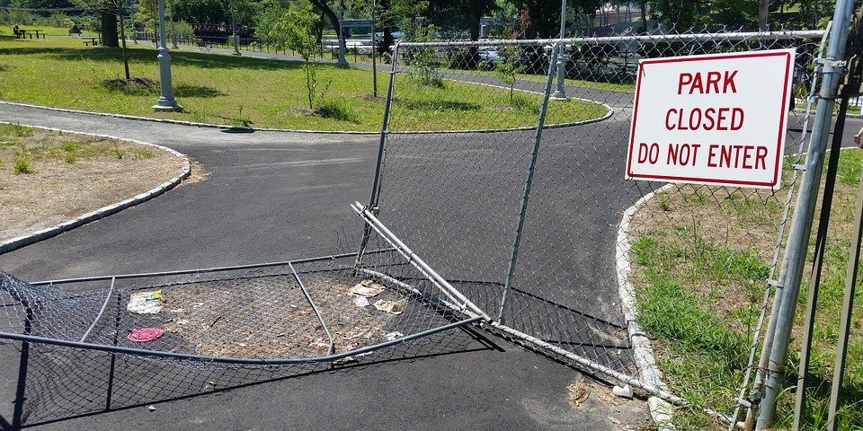 chain link gate to park is smashed in. Photo by Pixabay.com