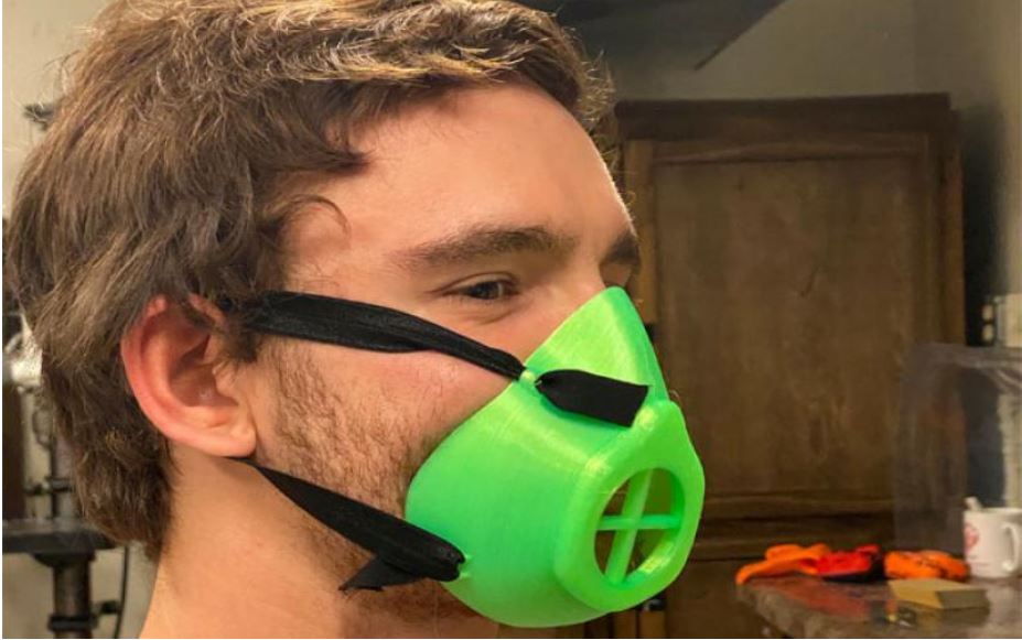 student wears a mask fabricated especially for those with spinal cord injuries
