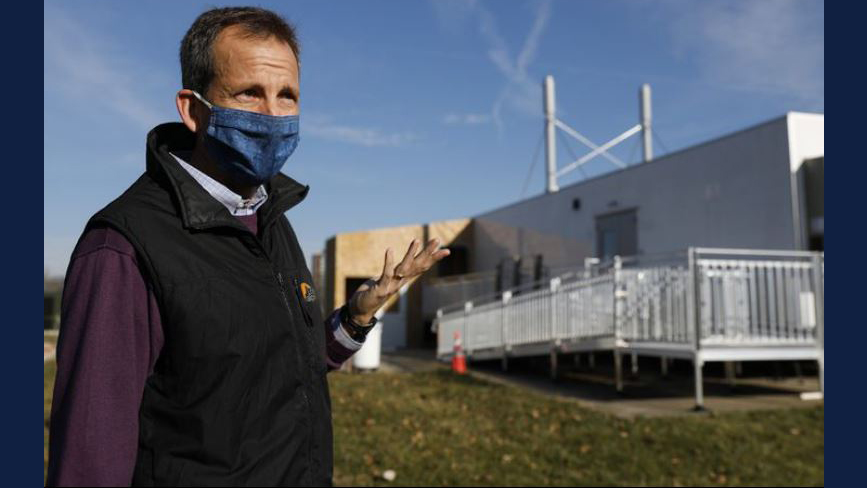 Harley Johnson, associate dean of research at Grainger College of Engineering, stands outside a mobile unit where up to 10,000 saliva samples per day are processed. Johnson oversaw the team that built and designed the mobile unit. (Jose M. Osorio / Chicago Tribune)