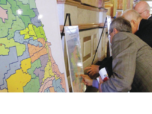 Pols review congressional maps. Photo by SAGA Communications